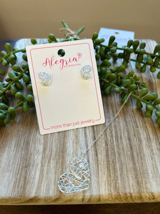 Dear Heart wire-wrapped earrings and matching necklace set displayed on wooden surface with greenery