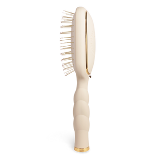 Tan detangler hair brush with curved handle and flexible bristles for gentle detangling
