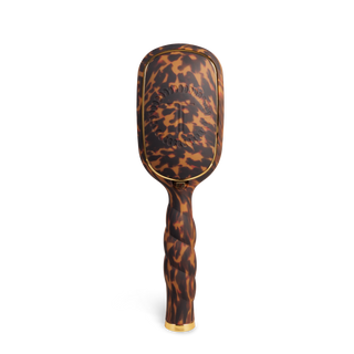 TELETIES detangler hair brush with tortoiseshell pattern and curved bristles on white background