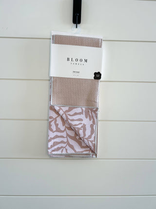 Bloom Towels dish towel in packaging hanging on white wooden wall display