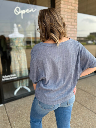 Woman wearing Blu Pepper Dusty Blue Dream Top with ribbed texture, paired with blue jeans.