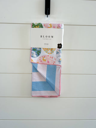Bloom Towels Egg Basket Kitchen Towel hanging in clear packaging against white shiplap wall