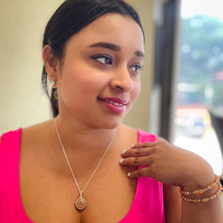 Woman wearing beaded bracelet on wrist with matching necklace, showcasing elegant jewelry accessories.