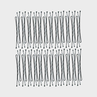 Black bobby pins arranged in organized rows showing hair accessory product set