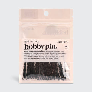 Package of black bobby pins in clear plastic pouch with pink product packaging and branding.