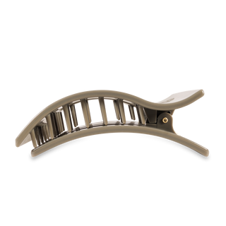 Large flat rectangle hair clip with curved design and vertical teeth in neutral tone