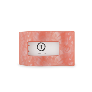 TELETIES flat rectangle hair clip in translucent coral orange with brand logo on white background