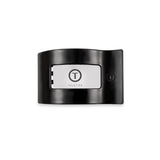 TELETIES flat rectangle hair clip with branded logo panel and textured side button detail.