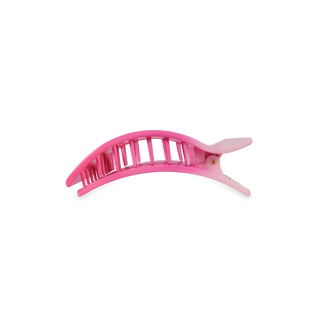Pink rectangular hair clip with curved design and textured grip surface
