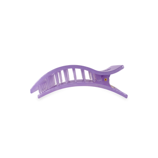 Purple rectangular hair clip with textured grip surface and curved design on white background