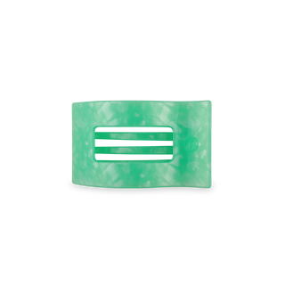 Green translucent rectangular hair clip with ridged grip surface on white background