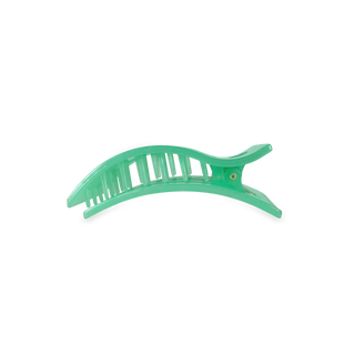 Green translucent hair clip with curved design and textured grip surface on white background.