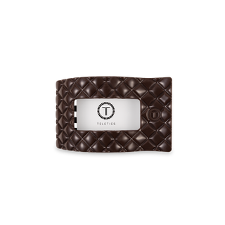 TELETIES quilted leather hair clip with logo displayed on black stand