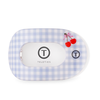 TELETIES flat round hair clip in gingham pattern with cherry design on clear packaging