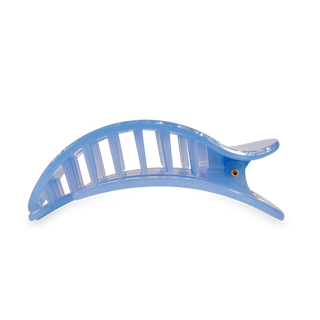 Blue transparent curved hair clip with ridged design and black grip pads