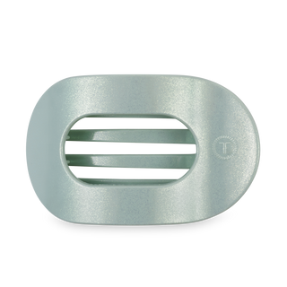 Light green translucent round hair clip with ribbed grip interior and curved ergonomic design.