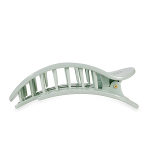 TELETIES flat round hair clip with curved design and ribbed grip pattern on white background