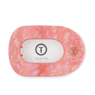 TELETIES flat round hair clip in translucent pink resin with brand logo on white background