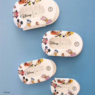 Four white oval hair clips featuring colorful Disney Mickey and Friends character patterns displayed on blue background.