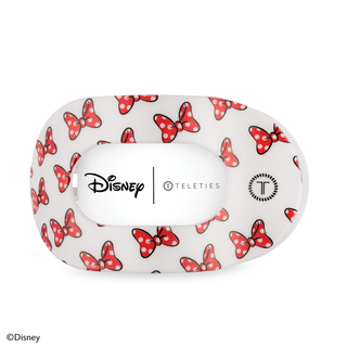 White hair clip with red polka dot bow pattern featuring Disney and TELETIES branding