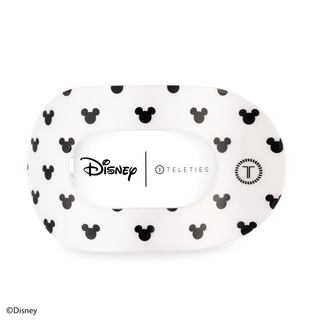 White oval hair clip with black and gray Mickey Mouse head pattern, Disney and TELETIES branding.