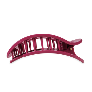 Pink curved hair clip with vertical slats and lever clasp mechanism