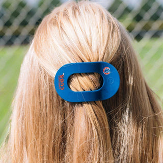 Woman wearing blue TELETIES flat round hair clip with Chicago Cubs logo in blonde ponytail outdoors.