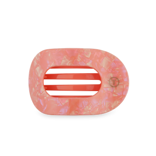 Pink translucent hair clip with oval opening and black grip tabs on clear background
