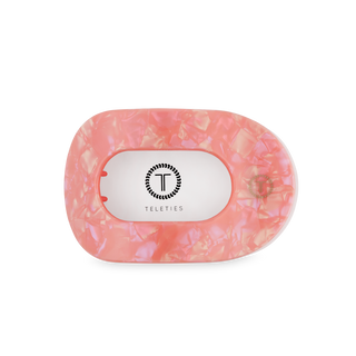 TELETIES flat round hair clip in translucent pink resin with brand logo on white background