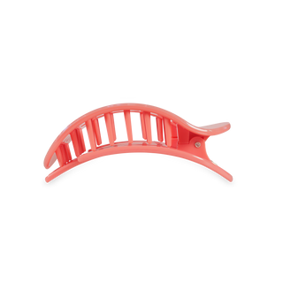 Pink curved hair clip with vertical slat design and black grip pads