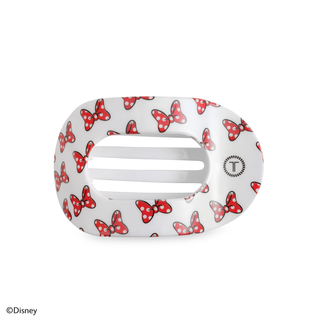 White oval hair clip with red polka dot bow pattern and brand logo