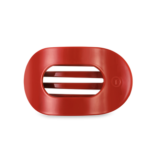 Red oval-shaped hair clip with ridged grip interior and smooth exterior finish