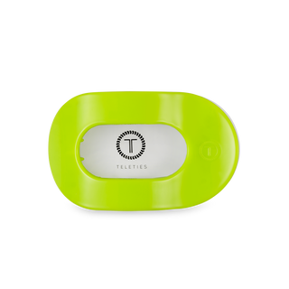 Bright green oval-shaped flat round hair clip with TELETIES logo on white background