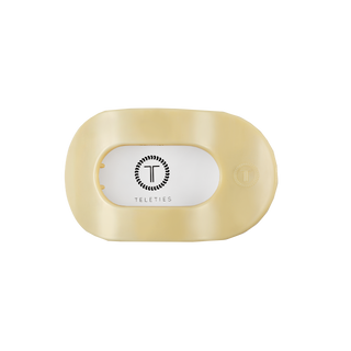 TELETIES flat round hair clip in translucent material with white oval logo label