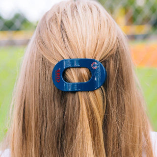 Woman wearing blue Chicago Cubs flat round hair clip in blonde hair outdoors
