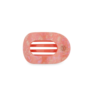Pink marbled hair clip with oval opening and black grip strips on white background