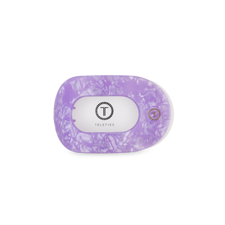 TELETIES flat round hair clip in clear packaging with purple translucent design
