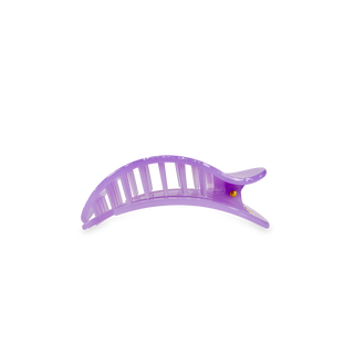Purple translucent flat round hair clip with ribbed texture and curved design on white background