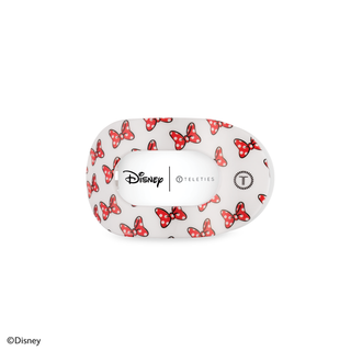 White hair clip with red Minnie Mouse bow pattern, Disney and Teleties branding visible on packaging.
