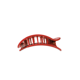 Red curved hair clip with vertical slat design and smooth finish