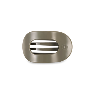 Flat round hair clip with oval opening and ridged interior grip design