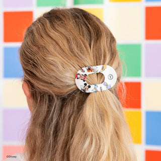 Woman wearing TELETIES flat round hair clip with Disney Mickey and Friends pattern in blonde hair