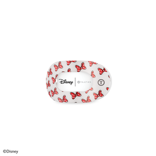 White hair clip with red polka dot bow pattern featuring Disney and TELETIES branding