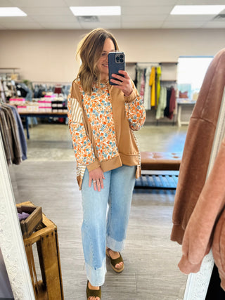 Woman wearing Haptics colorblock top with floral and striped panels, paired with wide-leg jeans.