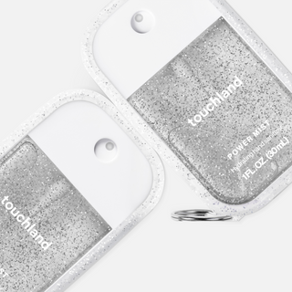 Two Touchland Power Mist hand sanitizer bottles in a glitter-filled frosted case with keyring attachment.