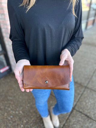 Woman holding brown leather wallet with snap closure from Kemp's Krafts