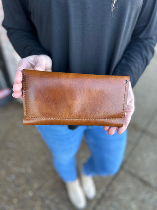 Person holding brown leather wallet with visible stitching and crafted details by Kemp's Krafts