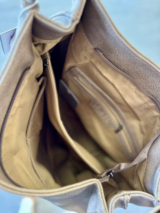 Open beige leather tote bag showing interior compartments and zippered pockets with fabric lining.