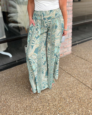 Panni Luv Golden Sage Palazzo Pant featuring wide-leg silhouette with paisley print and smocked waistband.