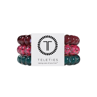 Three spiral coil hair ties by TELETIES stacked together with branded packaging card.